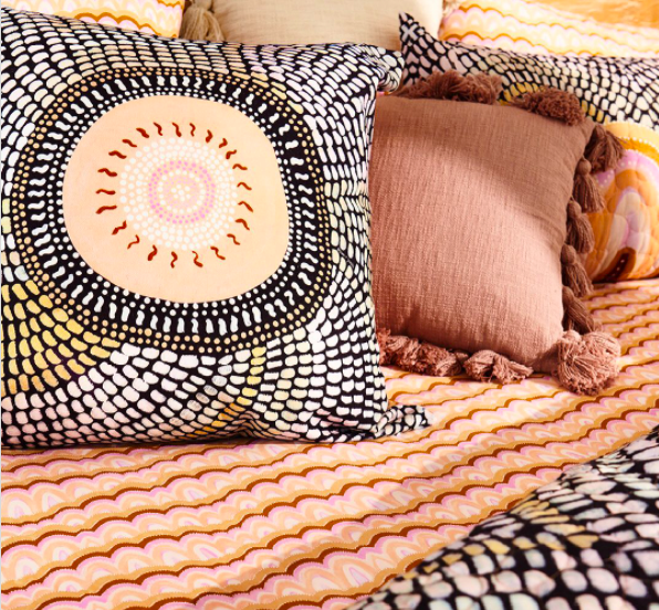 colourful patterned cushions and bedspread